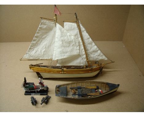 Scale model of a twin masted sailing boat, another of a rowing boat, die-cast cannons and the original Lambretta 1967 