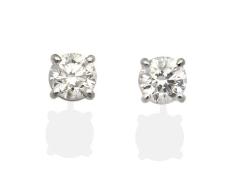 A Pair of 18 Carat White Gold Solitaire Diamond Earrings, round brilliant cut diamonds in claw settings, total estimated diam