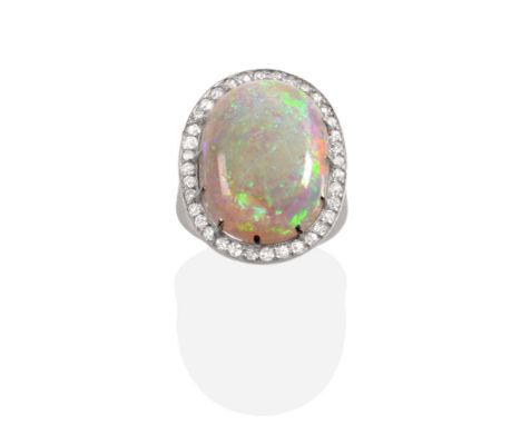 An Early 20th Century Opal and Diamond Cluster Ring, an oval cabochon opal in a claw setting, within a milgrain set eight-cut