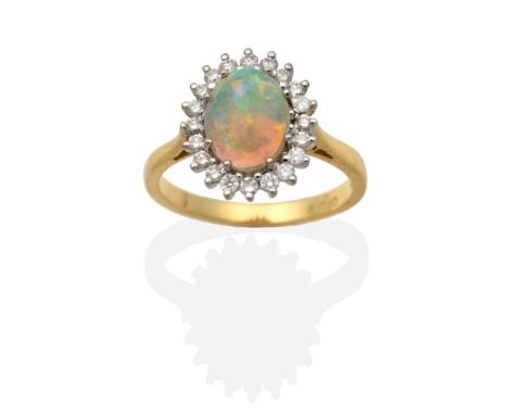 An 18 Carat Gold Opal and Diamond Cluster Ring, an oval cabochon opal in a claw setting, within a border of round brilliant c