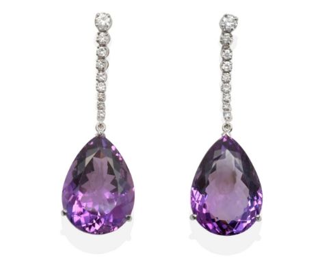 A Pair of 18 Carat White Gold Amethyst and Diamond Earrings, a pear cut amethyst in a claw setting, suspended from an articul