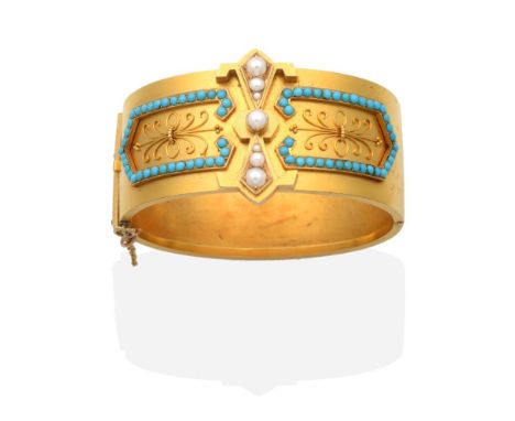 A Victorian Pearl and Turquoise Bangle, an applied panel of seed pearls, to turquoise and seed pearl borders, with cannetille