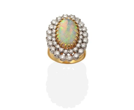 An 18 Carat Gold Opal and Diamond Cluster Ring, an oval cabochon opal in a claw setting within a two tier border of graduated