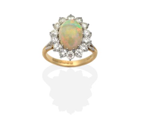 An 18 Carat Gold Opal and Diamond Cluster Ring, an oval cabochon opal within a border of round brilliant cut diamonds, to for