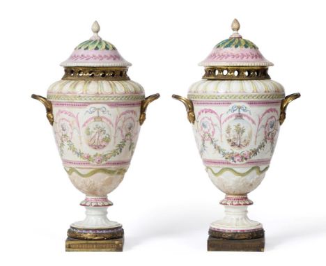 A Pair of Buen Retiro Porcelain Pot Pourri Vases and Covers, circa 1790, painted with neo-classical arabesques, with foliage 