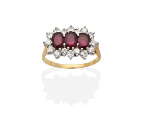 An 18 Carat Gold Ruby and Diamond Cluster Ring, three oval cut rubies within a border of round brilliant cut diamonds, to kni