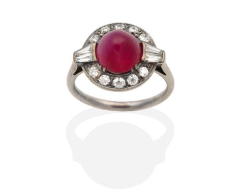 An Art Deco Ruby and Diamond Ring, a high domed round cabochon ruby within a border of old cut and tapered baguette cut diamo