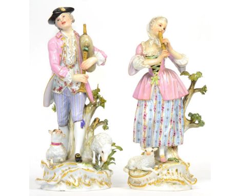 A Pair of Meissen Porcelain Figures of a Shepherd and Shepherdess, late 19th century, he playing bagpipes, a dog and ewe at h