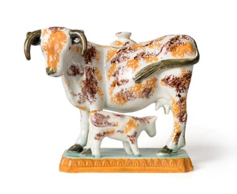 A Prattware Cow Creamer and Cover, circa 1810, possibly St Anthony's Newcastle, modelled as a standing beast, a calf at its f