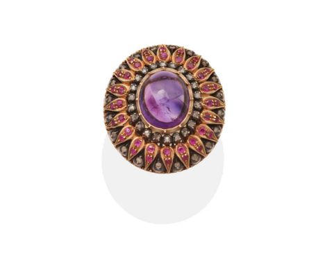 A Large Amethyst, Ruby and Diamond Cluster Ring, an oval cabochon amethyst within a domed cluster of round cut rubies and sin