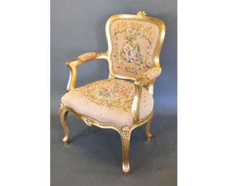 A French Gilded Armchair with a tapestry upholstered back and seat raised upon cabriole legs with scroll feet 