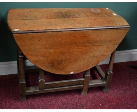 A SMALL OAK DROP-LEAF GATE-LEG TABLE, with demi-lune flaps, early 20th century, 36" (91cm) wide. (1)