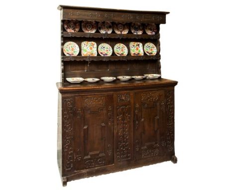 AN EARLY OAK DRESSER, probably Continental, the two-shelf back with iron hooks and plate racks, on a base with a single friez