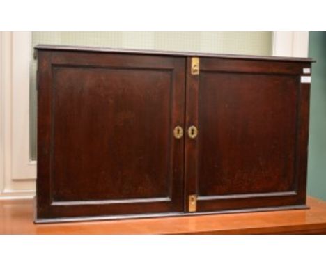 AN UNUSUAL GEORGIAN MAHOGANY TABLE TOP TWO DOOR CUPBOARD, the panelled doors enclosing a six concave shelf, 20"(51cm)h x 35" 