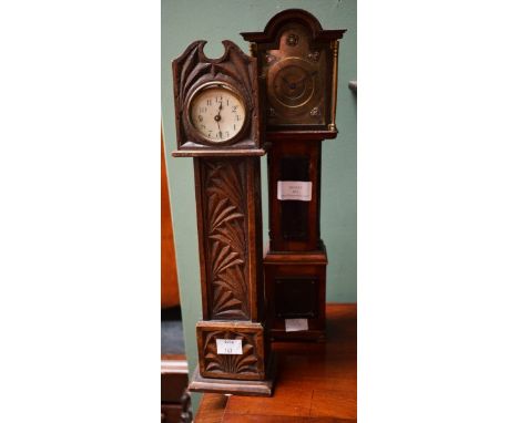 A MINIATURE MODEL OF A LONGCASE CLOCK, with arched and moulded pediment and a brass dial, 14.75" (37.5cm); together with anot