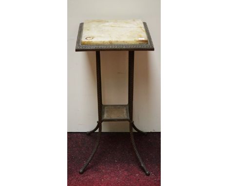 AN EDWARDIAN BRASS TWO TIER JARDINIERE TABLE, with onyx top, and square stretcher shelf, on rope moulded tubular brass legs