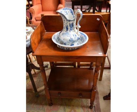 A 19TH CENTURY MAHOGANY WASH STAND, with three quarter gallery and lower shelf with drawer, on turned supports, 25" (64cm)d, 