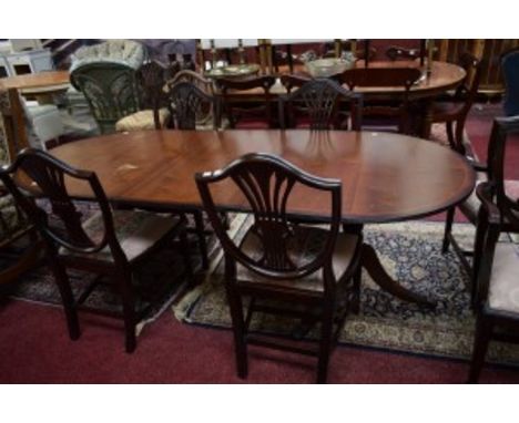 A SET OF SIX (4+2) HEPPLEWHITE STYLE MAHOGANY DINING CHAIRS, each shield shaped back with a pierced splat, crested with a whe