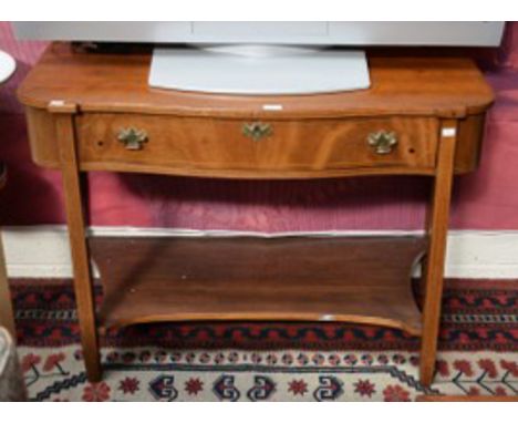 AN INLAID MAHOGANY SIDE TABLE, the serpentine shaped top, with one long conforming drawer, raised on square inlaid legs, unit