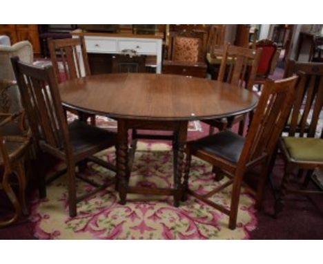 AN OVAL DROP LEAF OAK GATE LEG TABLE, with barley twist supports, 5ft (151cm) extended; together with a set of six oak triple