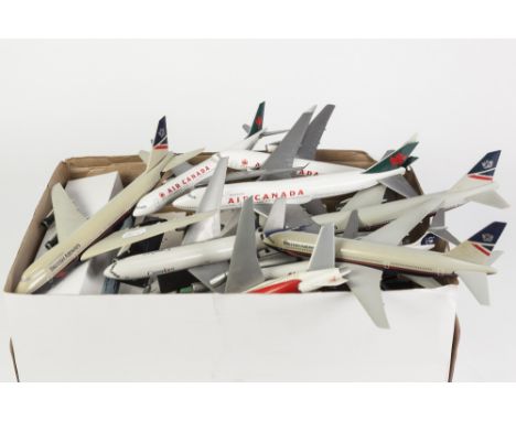 NINE MADE-UP PLASTIC PUSH TOGETHER MODELS OF PASSENGER AIRCRAFT each on stand, as display model, the largest being 11" (28cm)