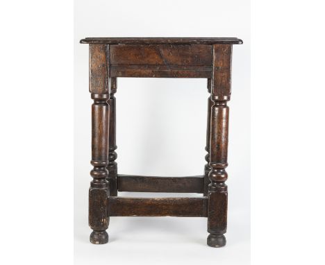EIGHTEENTH CENTURY AND LATER OAK JOINTED STOOL, with moulded oblong top and turned supports, tied by square stretchers, 22 ½"