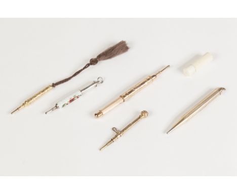 GOLD CASED PROPELLING PENCIL, with pull and extend action, the case with embossed decoration of birds and berries, unmarked b