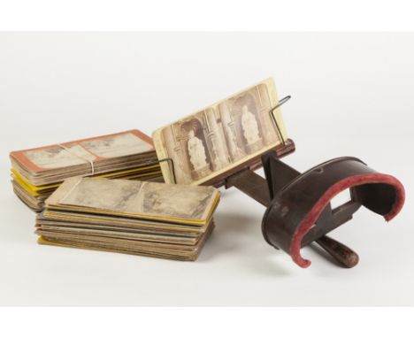 EARLY 20th CENTURY STAINED WOOD HAND-HELD STEREOSCOPIC VIEWER of typical form with folding handle and slide holder, 12" (30.5