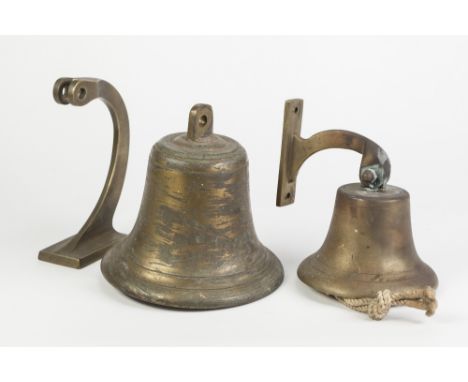 HEAVY BRASS BULKHEAD TYPE BELL pivoting on a scroll shaped wall bracket, 8" (20.3cm) diameter (lacks bracket pin) and a small