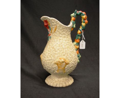 Clarice Cliff 'Celtic Harvest' water jug with decorated fruit form handle, (small chip to handle), and embossed harvest decor