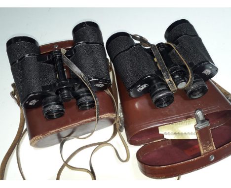 Two vintage pairs of binoculars in leather cases.  