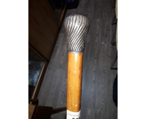 A silver handled walking stick.  