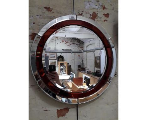 A 1930s Art Deco beveled glass circular mirror with amber interior circle panels, diameter 51.5cm.&nbsp;Overall condition is 