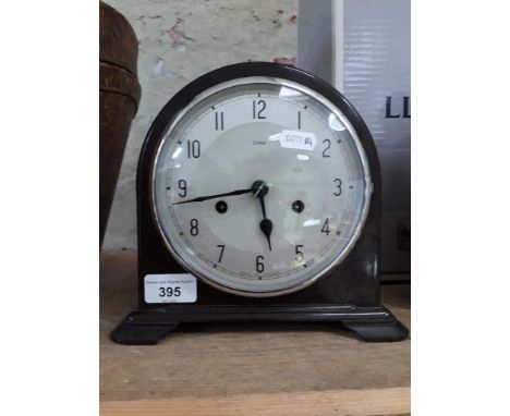 A Smith Enfield bakelite bracket clock with key and pendulum.The overall dimensions are as follows: height 20cm, width 22cm a