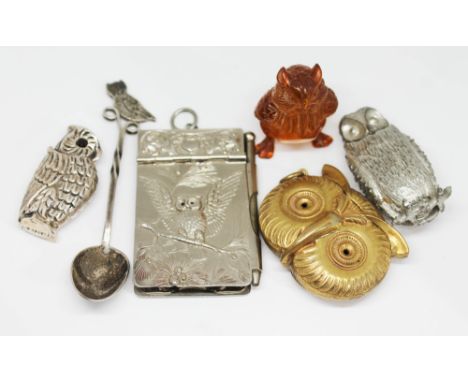 Assorted novelty owl items comprising a white emtal spoon, a silver plated note pad, a brass vesta case and another, a netsuk