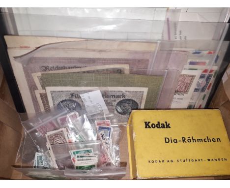 A box containing WWII German banknotes, coins, various stamps and vintage Berlin slides.  