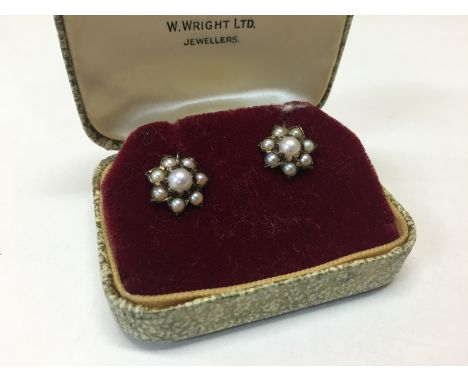 A PAIR OF CULTURED PEARL 9CT. GOLD FLOWERHEAD EARRINGS