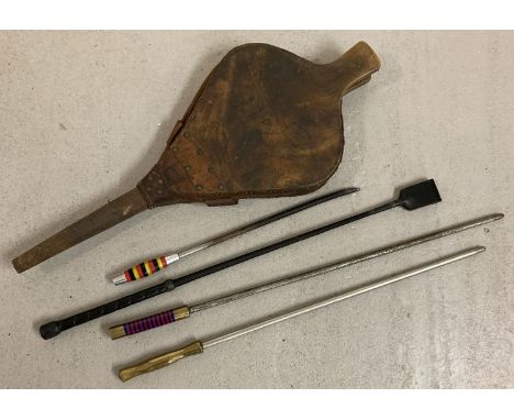 A vintage pair of wooden bellows together with 3 pokers with brass and coloured Lucite handles.  And a leather riding crop. 