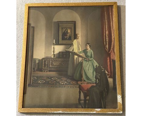 A vintage framed and glazed print of two women in Victorian dress doing needlework.   Frame size approx. 57 x 48cm.