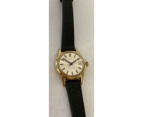 A ladies vintage Swiss made wristwatch by Doxa.  Gold tone case with silver face, gold and black hands &amp; hour markers and