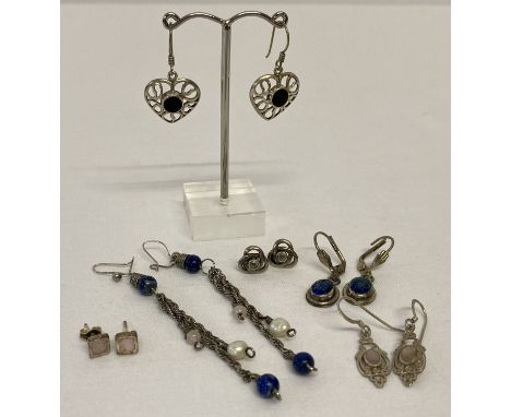 5 pairs of silver and white metal earrings in both drop and stud styles.  To include a pair of lapis lazuli set drops, onyx s
