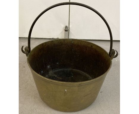 A vintage heavy brass jam pan with carry handle.   Approx. 32 cm diameter.