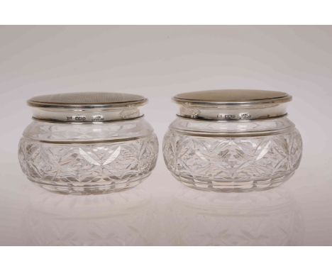 A PAIR OF SILVER MOUNTED CUT GLASS JARS, the pull off lids marked Walker & Hall, Sheffield 1951, with engine turned decoratio