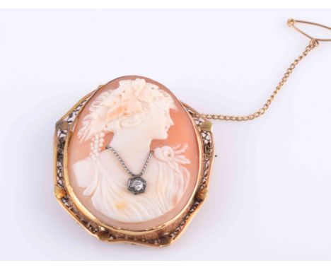 A VICTORIAN DIAMOND SET CAMEO BROOCH, the oval slightly domed cameo of the profile of a lady, wearing a necklace formed of tw