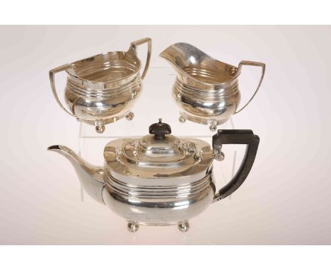A SILVER THREE PIECE TEA SERVICE, Birmingham 1920, of oval ribbed form, on bun feet. Gross 22oz