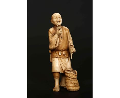 A FINE JAPANESE MEIJI PERIOD IVORY OKIMONO, the one piece carved as an old man smoking a pipe, a basket at his feet, holding 