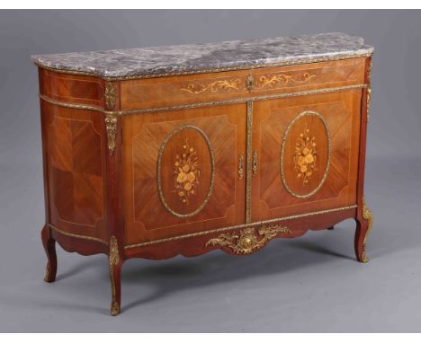 A FRENCH MARBLE TOPPED, KINGWOOD AND GILT METAL MOUNTED COMMODE, with shaped sides and long frieze drawer over a pair of cupb