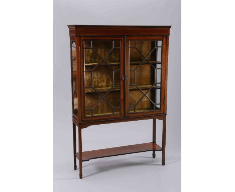 AN EDWARDIAN INLAID MAHOGANY VITRINE, with a pair of astragal glazed doors, raised on square section tapering legs, joined by