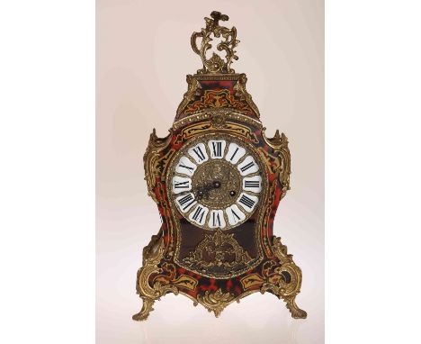 A FRENCH BOULLE STYLE MANTEL CLOCK, with a brass dial inset with enamel panels painted with Roman numerals. 56cm high