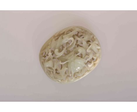 A CHINESE RETICULATED NEPHRITE JADE BELT PLAQUE, probably Qing Dynasty, celadon colour, carved with a dragon entwined among d